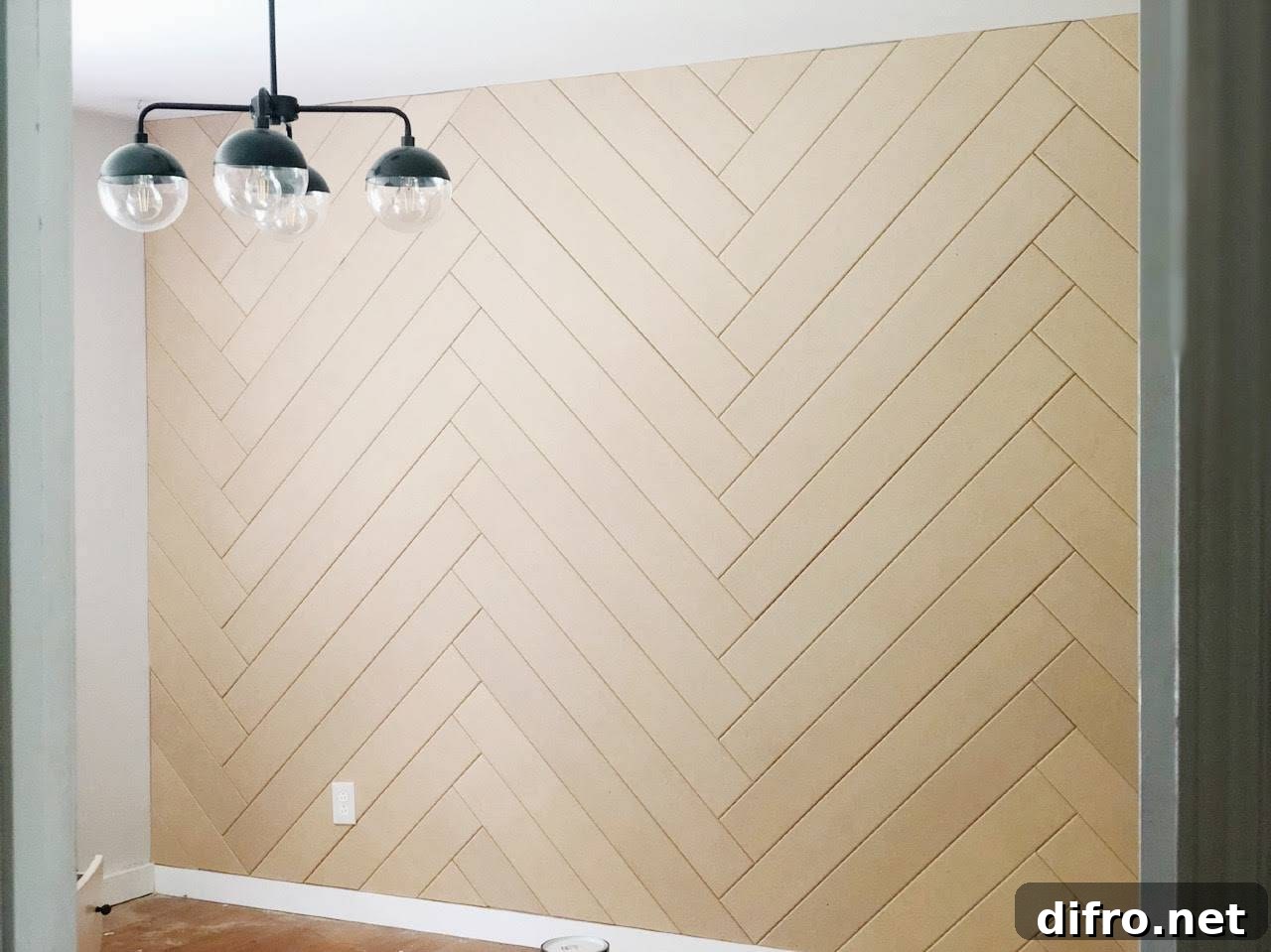 Chevron wood accent wall and a unique light fixture.