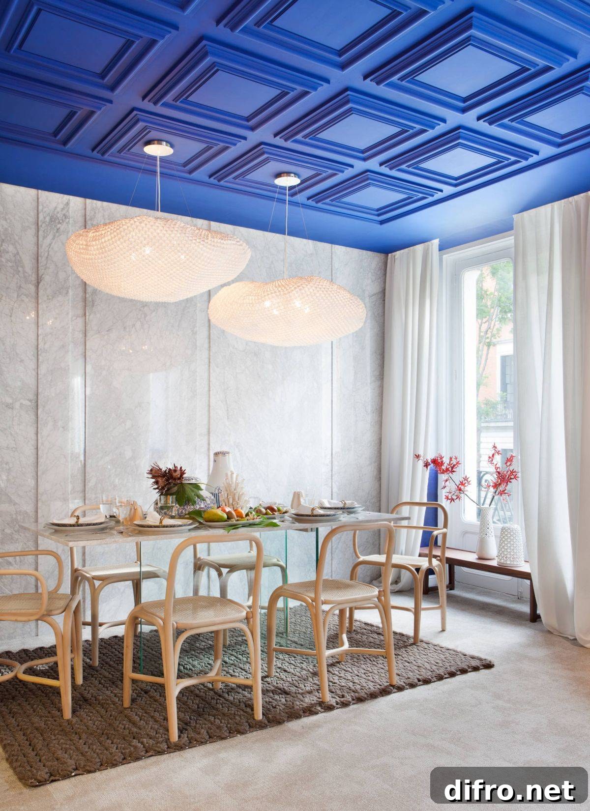 Coffered ceiling painted deep blue in a double-height dining room