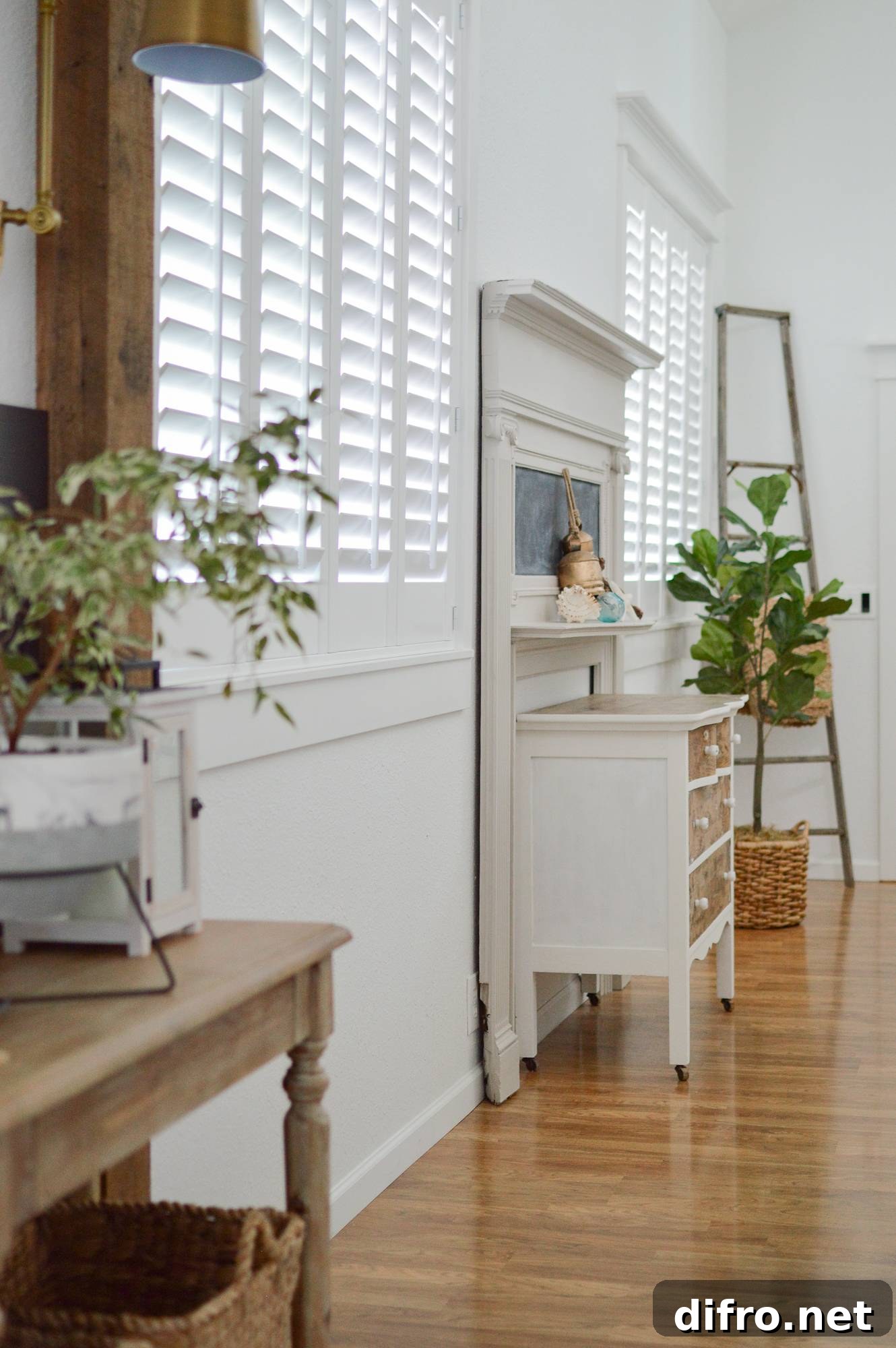Entryway finished with minimalist white styling and green plants.