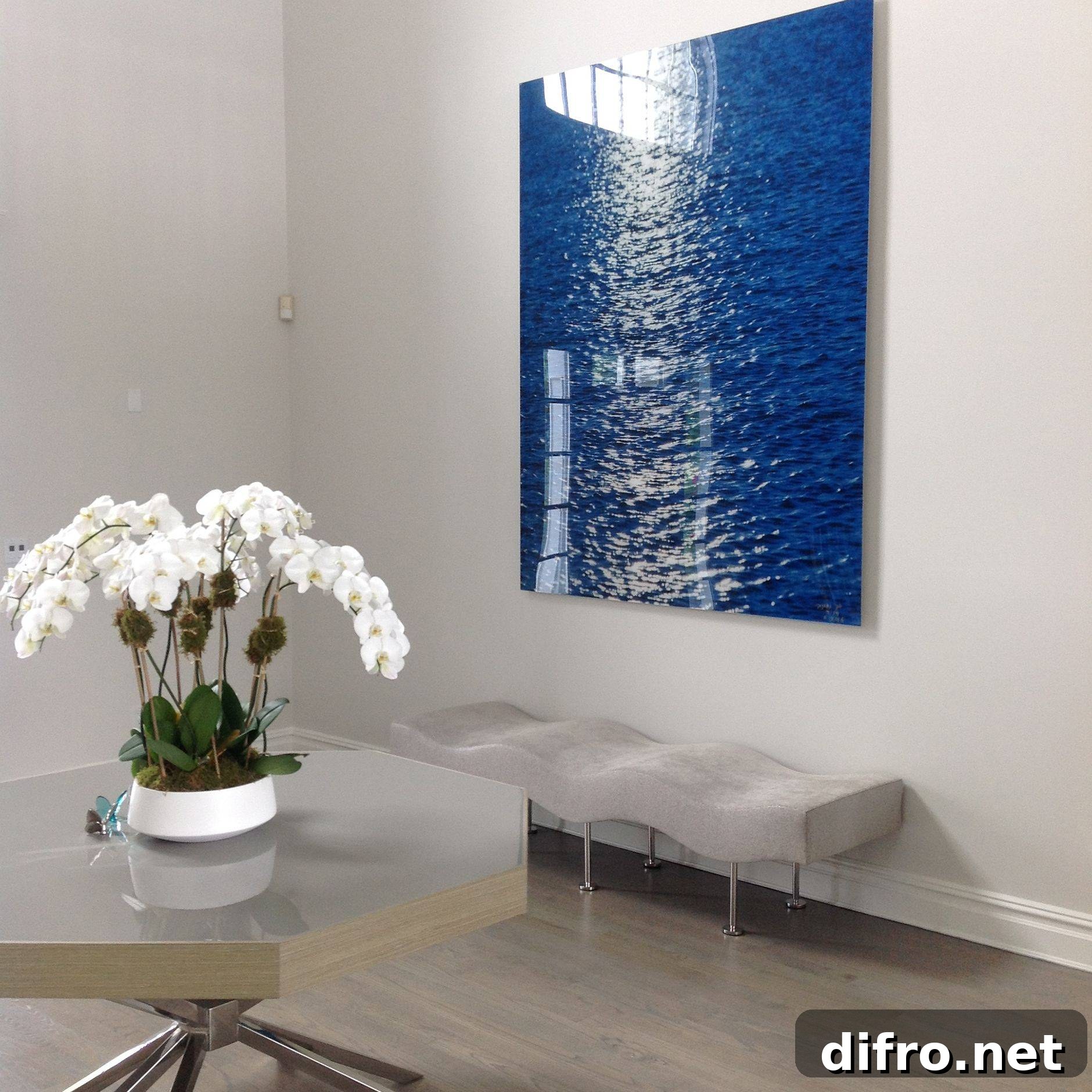 Entryway hosting a blue artwork piece that has a bench underneath it.