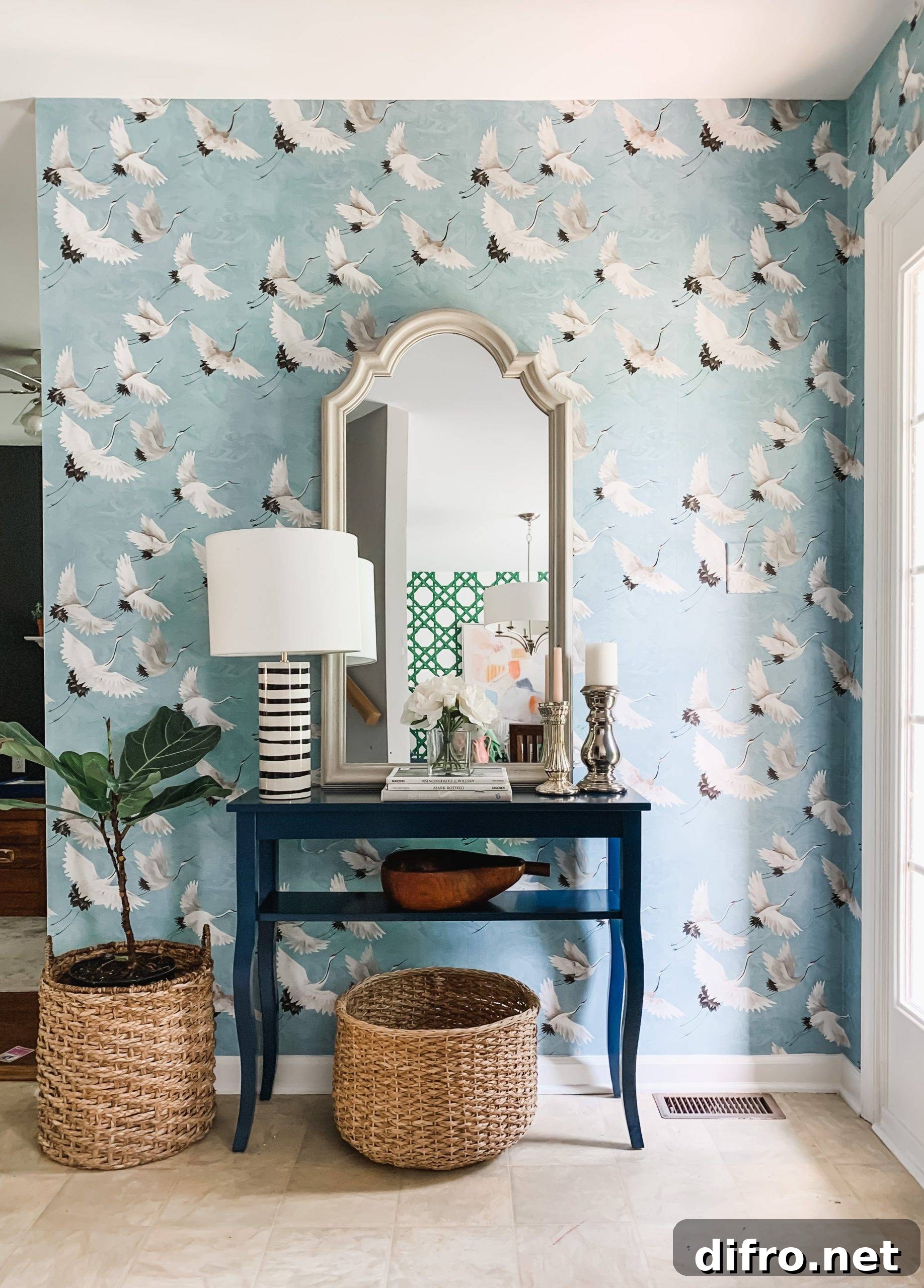 Entryway with a table that has a mirror, lamp, and wicker baskets under.