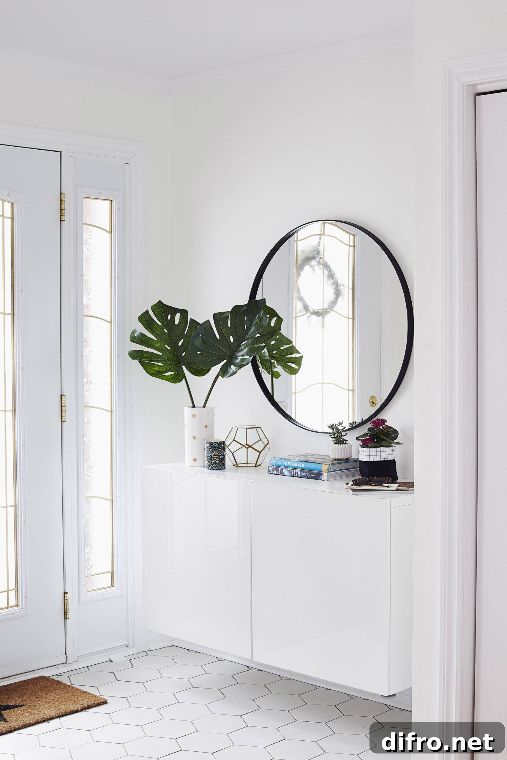 White entryway with storage and a large circular mirror.