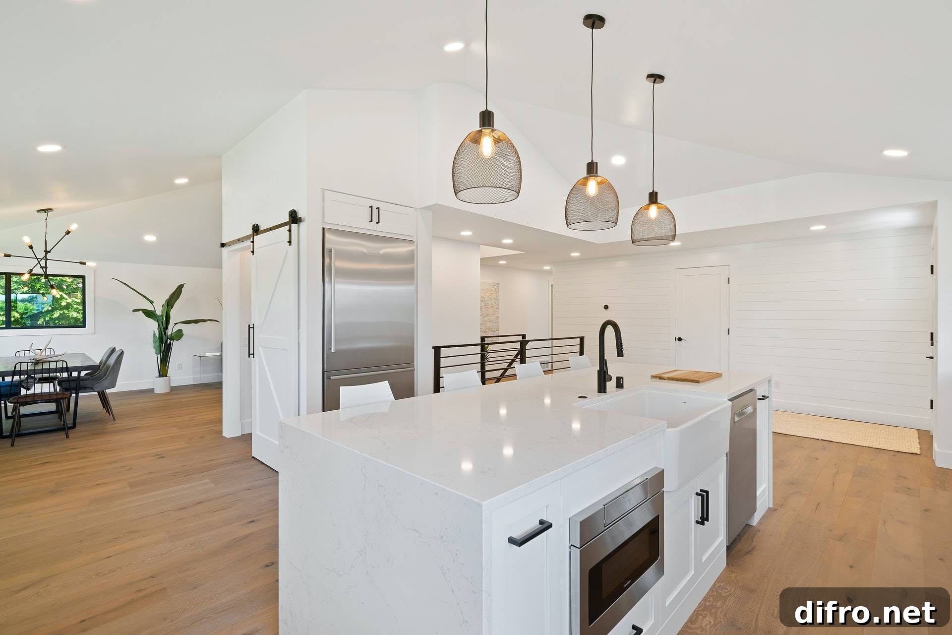 White kitchen featuring black netted pendant lights