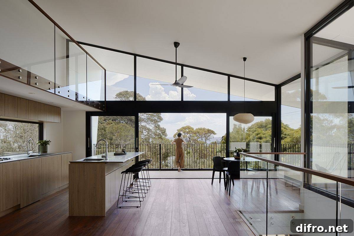 Open-plan living, kitchen and dining area on the upper level with double-height ceiling