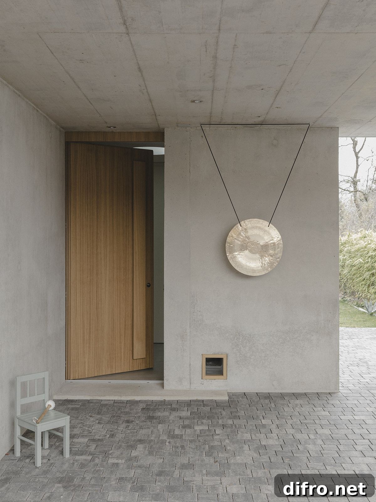 Wood and concrete entry with protected entryway