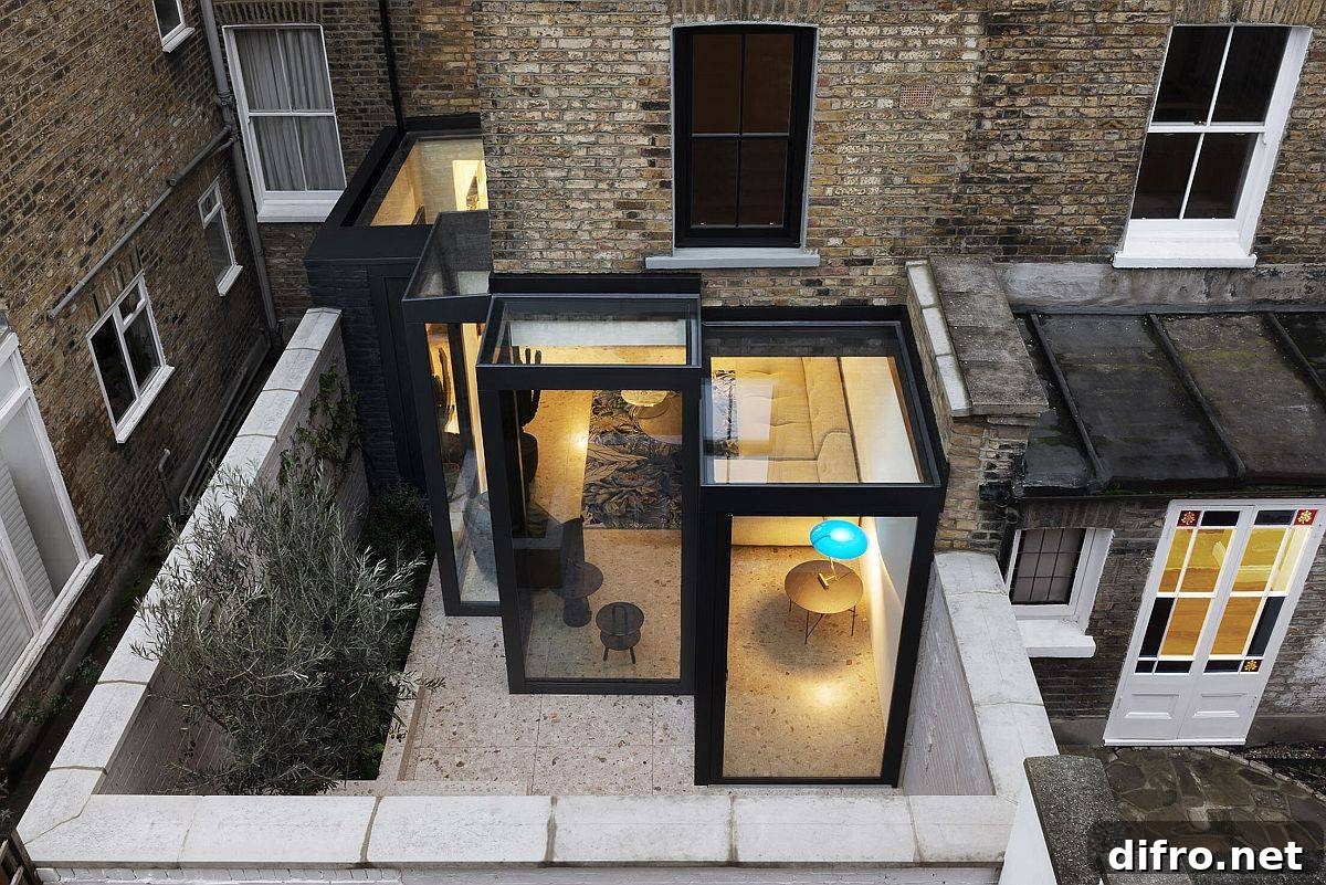 Custom box-style glass cabins extend the traditional London home