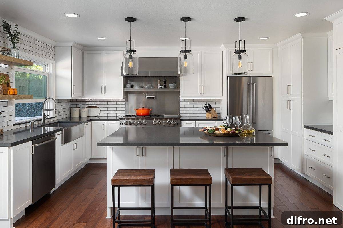 Countertops and appliances bring grey to this all-white kitchen