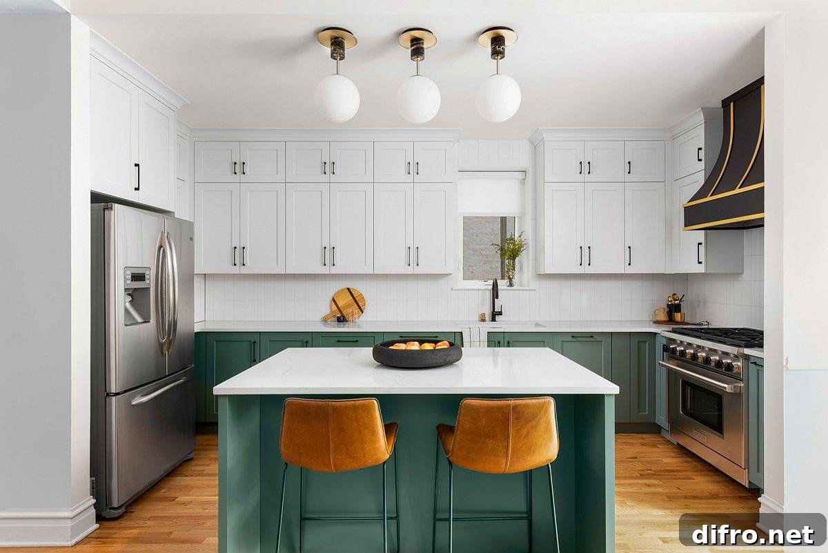 Polished white kitchen with a deep green island and cabinets