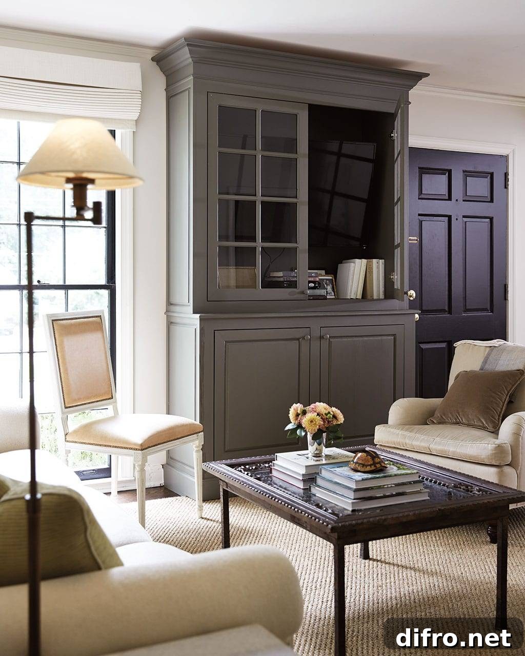 Television hidden behind cabinet doors in a living room
