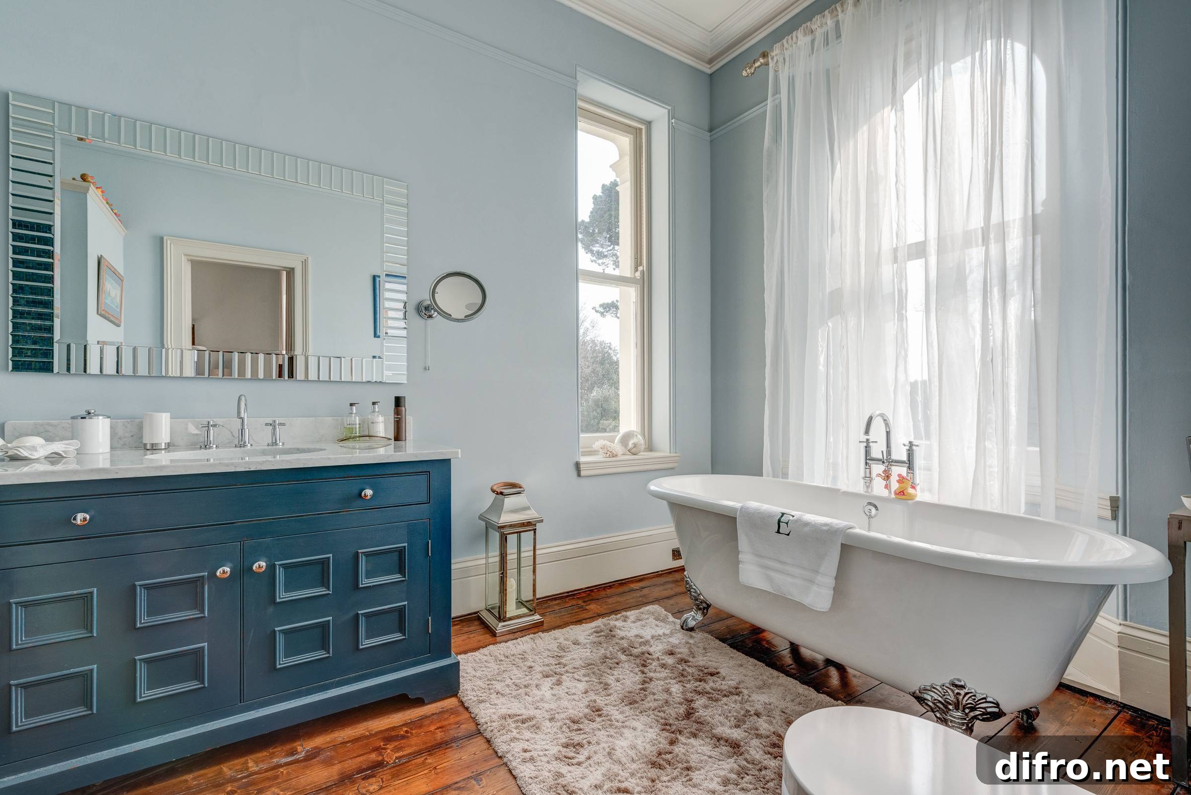 Sheer white curtains framing a bathroom window