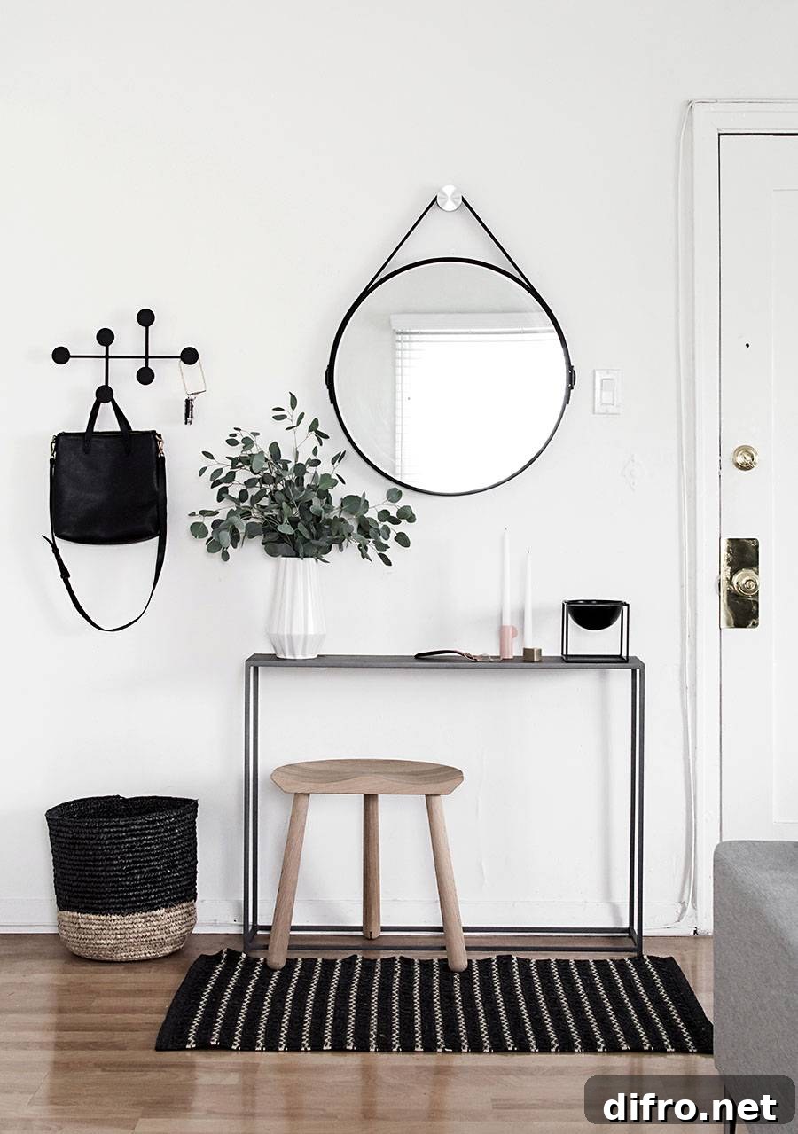 Narrow console table with woven basket and coat hooks