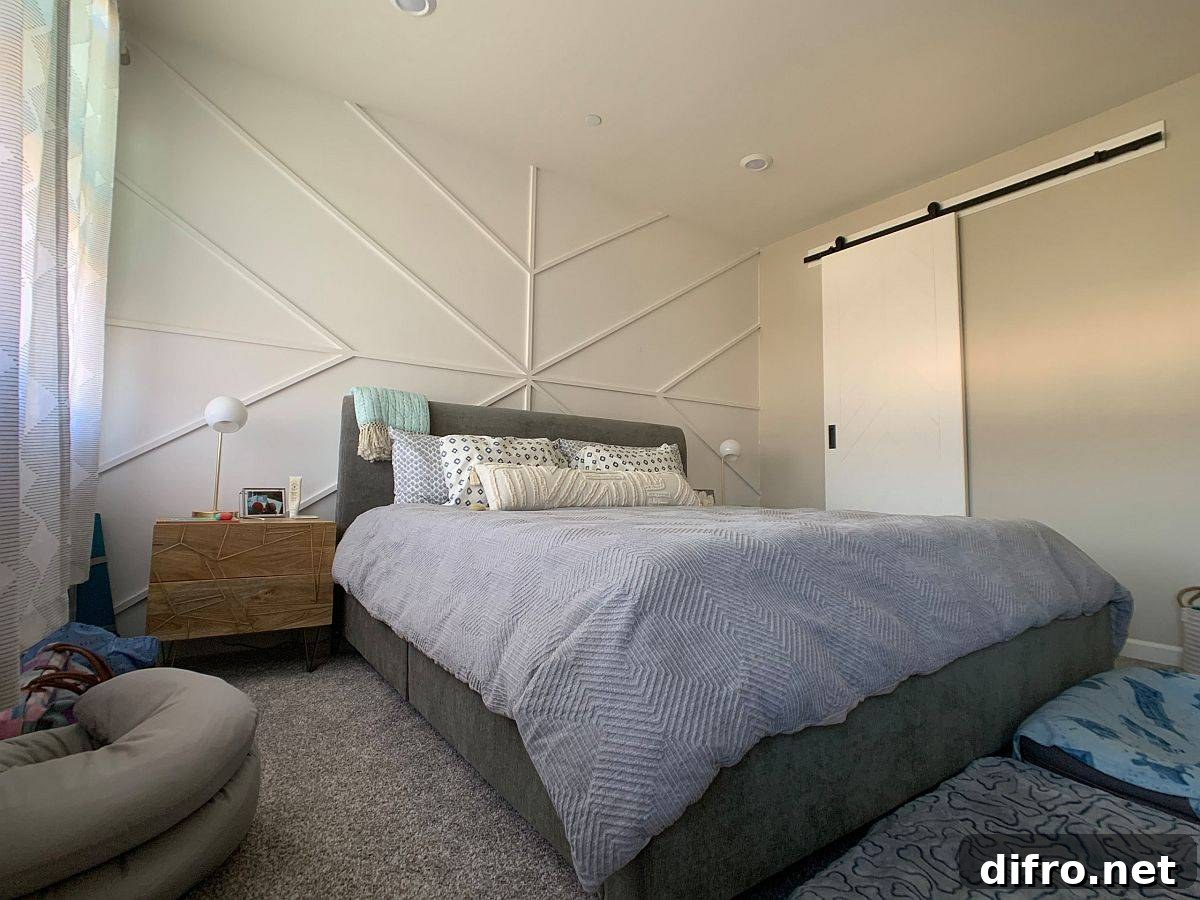 White geometric accent wall that preserves a small bedroom's color scheme
