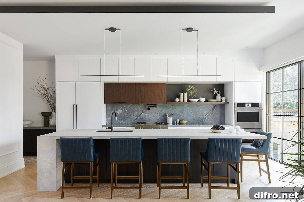 White kitchen with bluish-gray stone backsplash and blue bar chairs