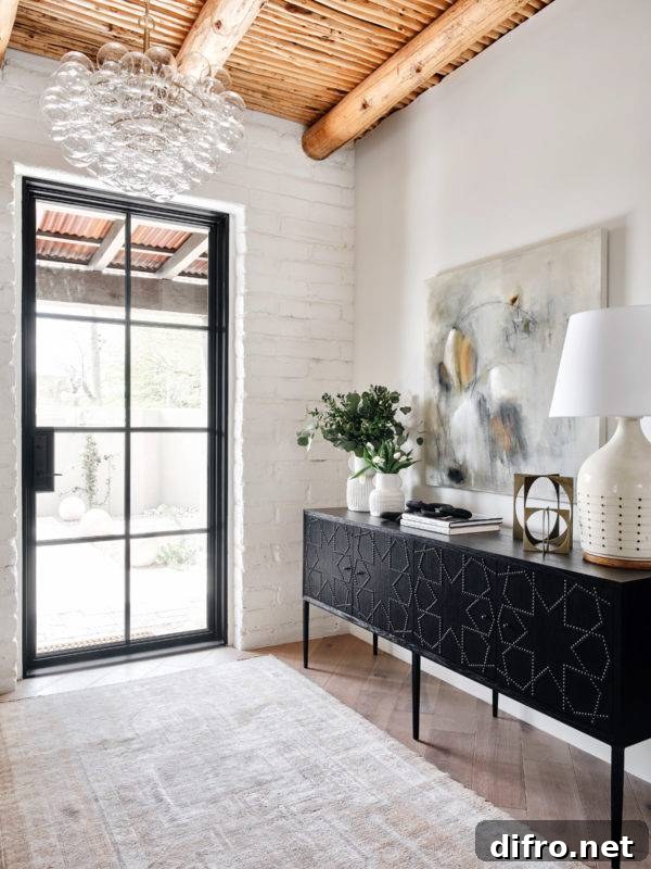 entryway to home with black patterned cabinet and plants
