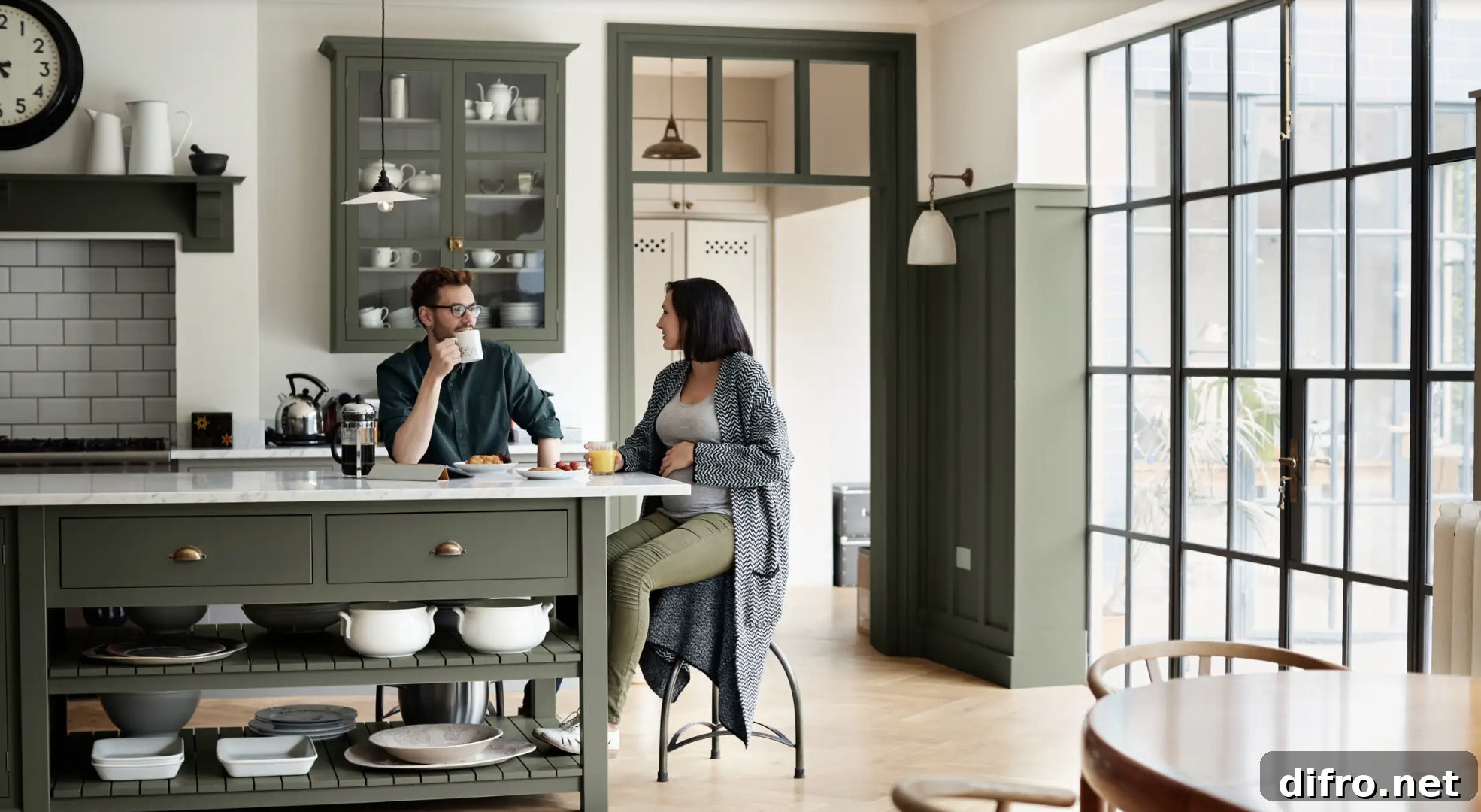 green kitchen man and woman sitting island