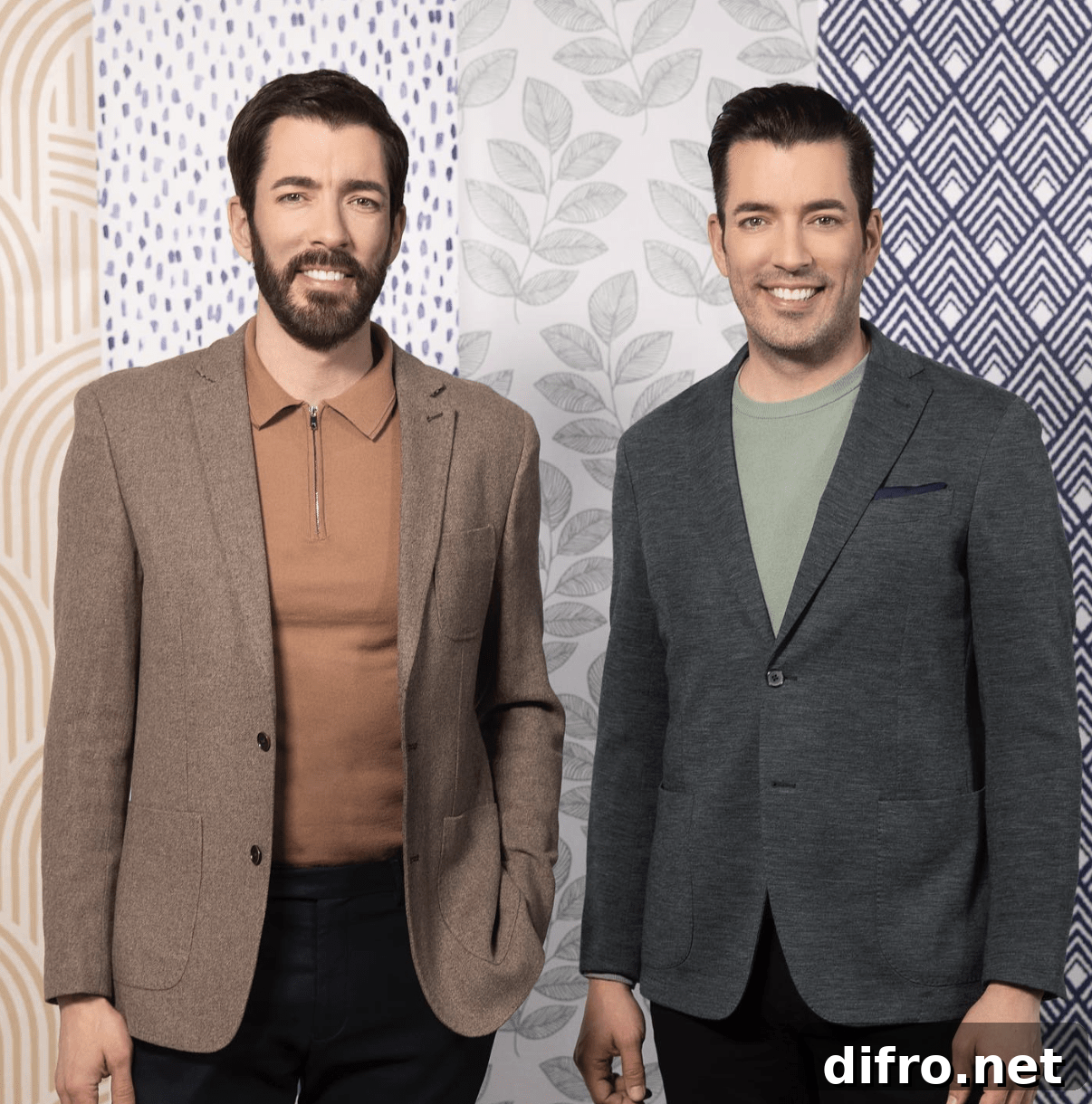 drew and jonathan scott property brothers standing in front of wallpaper wearing suits
