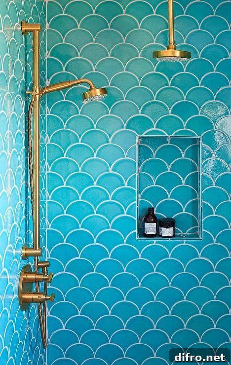 Shower features turquoise blue scale tiles and a brass shower head