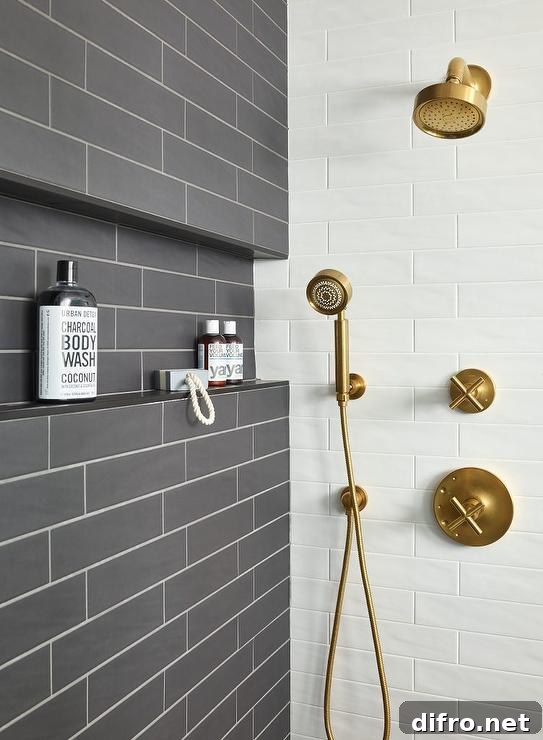 Dark gray glazed tiles walk-in shower with white grout and a brushed gold shower kit