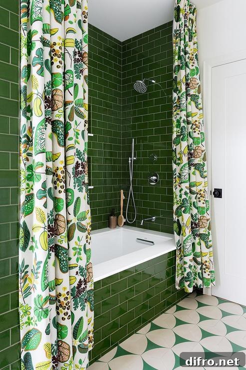 A green subway tiled drop-in bathtub covered with white and green shower curtains