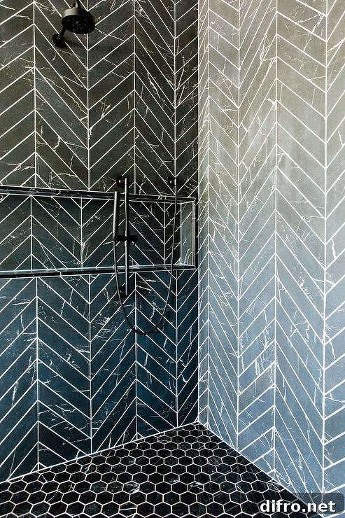 Black hexagon floor tiles complement black chevron shower surround tiles