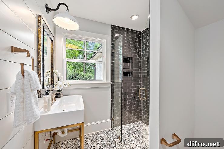 A white and gold sink with a brass base featuring a satin nickel faucet in a modern farmhouse bathroom