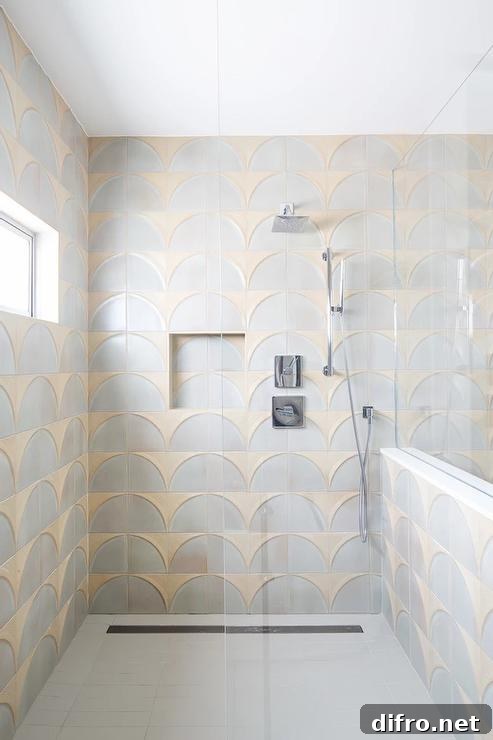 walk in shower in gold and gray wall tiles with an infinity drain