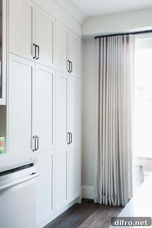 Floor-to-ceiling white curtains in a kitchen