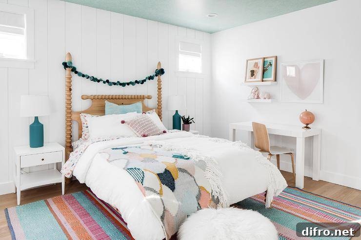 teal pink and mustard bedroom with pom pom garland and colorful rug