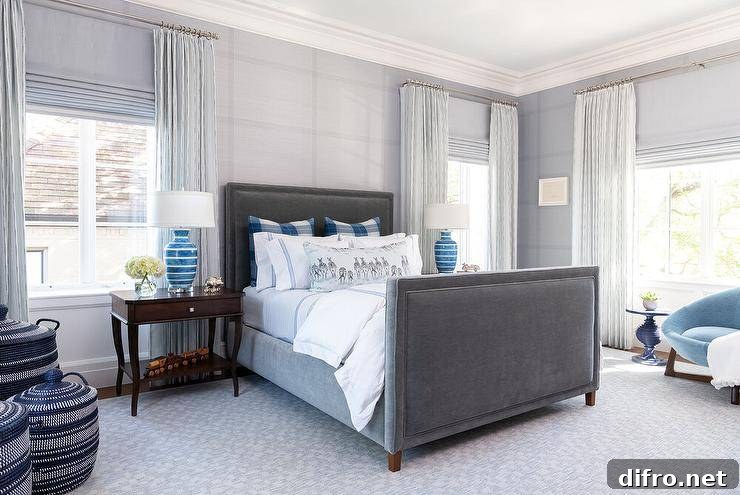 charcoal grey navy and blue bedroom with velvet headboard