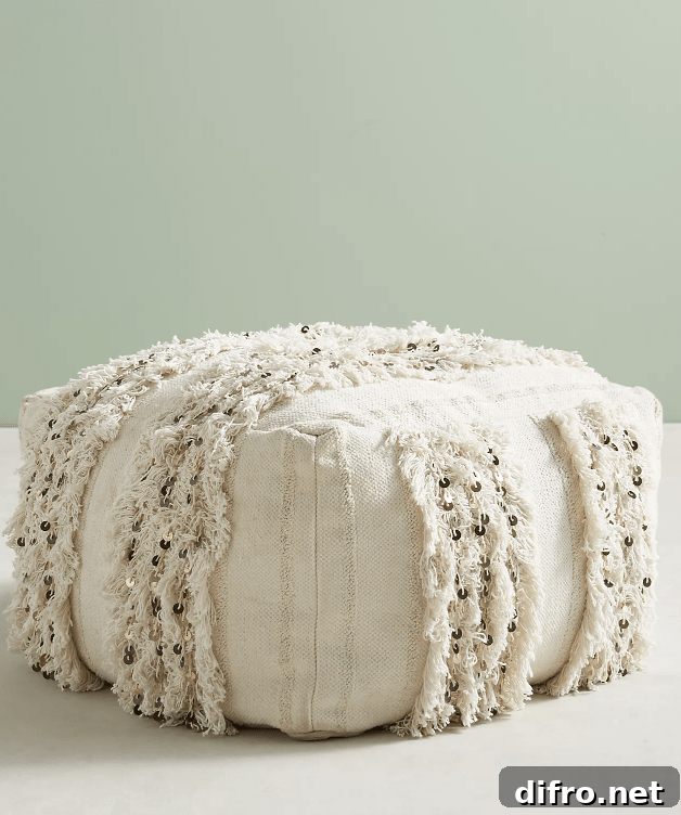 White Moroccan pouf on light background