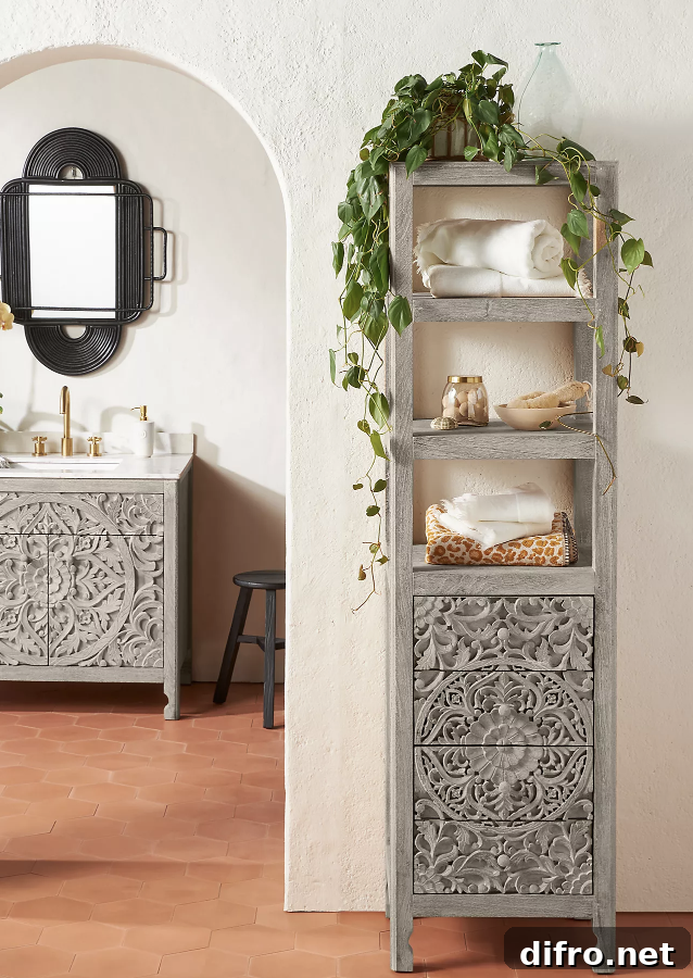 Grey wood-washed storage shelf with greenery and towels