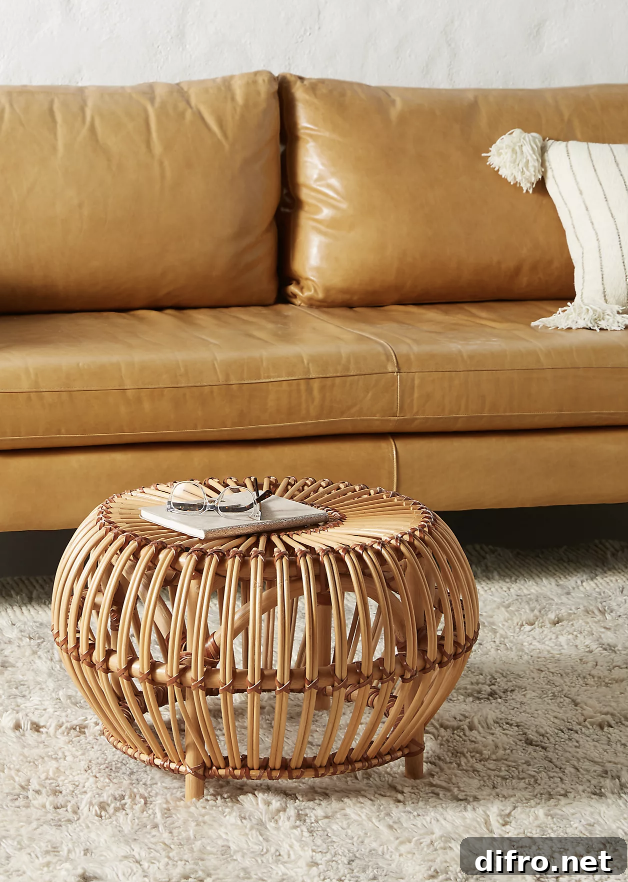 Rattan ottoman next to light brown leather couch