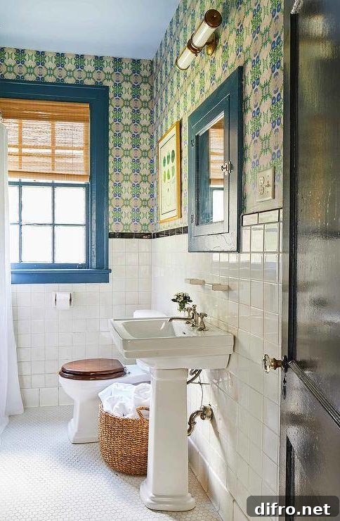 half bathroom with color framed window blue pedestal sink with bold wallpaper