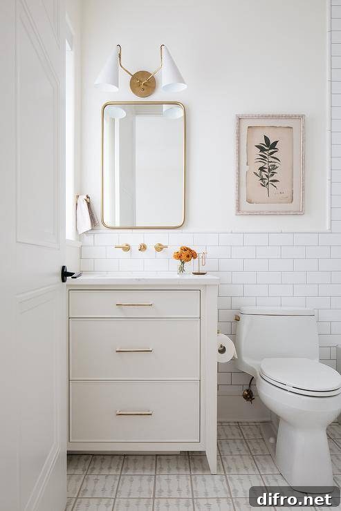 white neutral half bathroom with gold mirror and white vanity