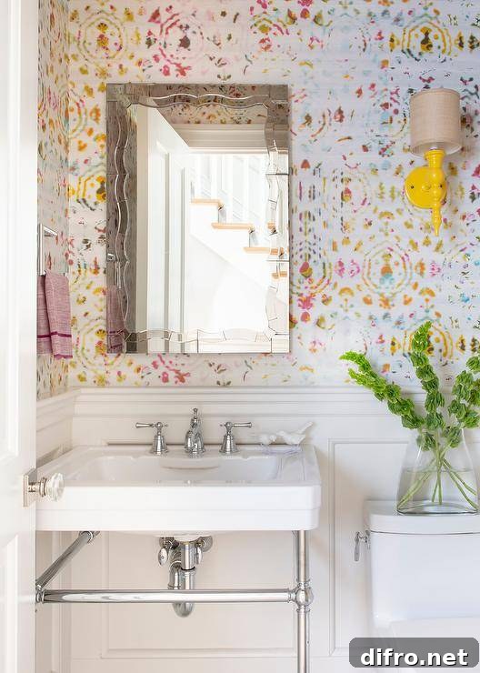 bold color wallpaper in half bathroom with yellow wall sconce pedestal sink