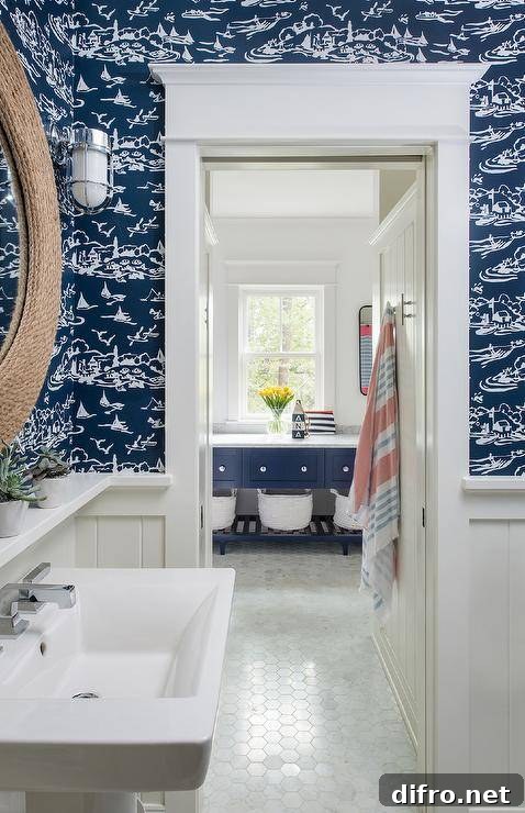 blue sailboat wallpaper in bathroom with white trim rope round mirror sink