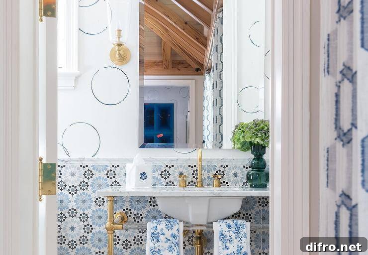 bold tile in half bathroom with gold faucet sink circle design on wall with gold sconce