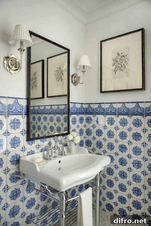 fancy tile in bathroom with pedestal sink black frame mirror and white wall sconces