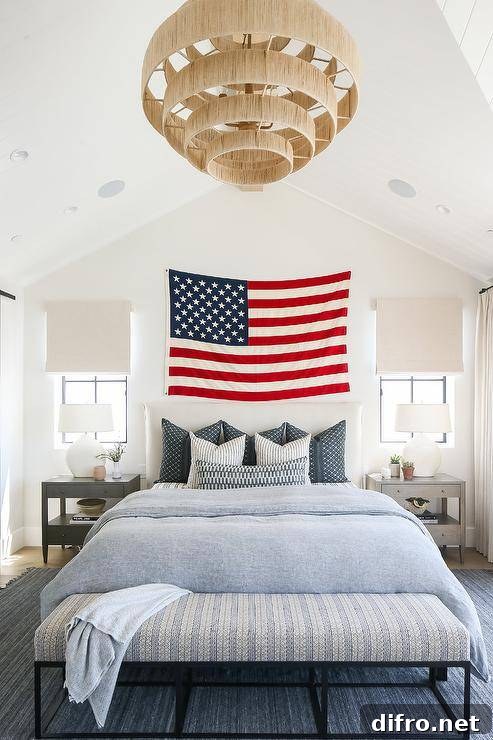 american flag hanging over bed light blue bedding white wall bedroom large chandelier