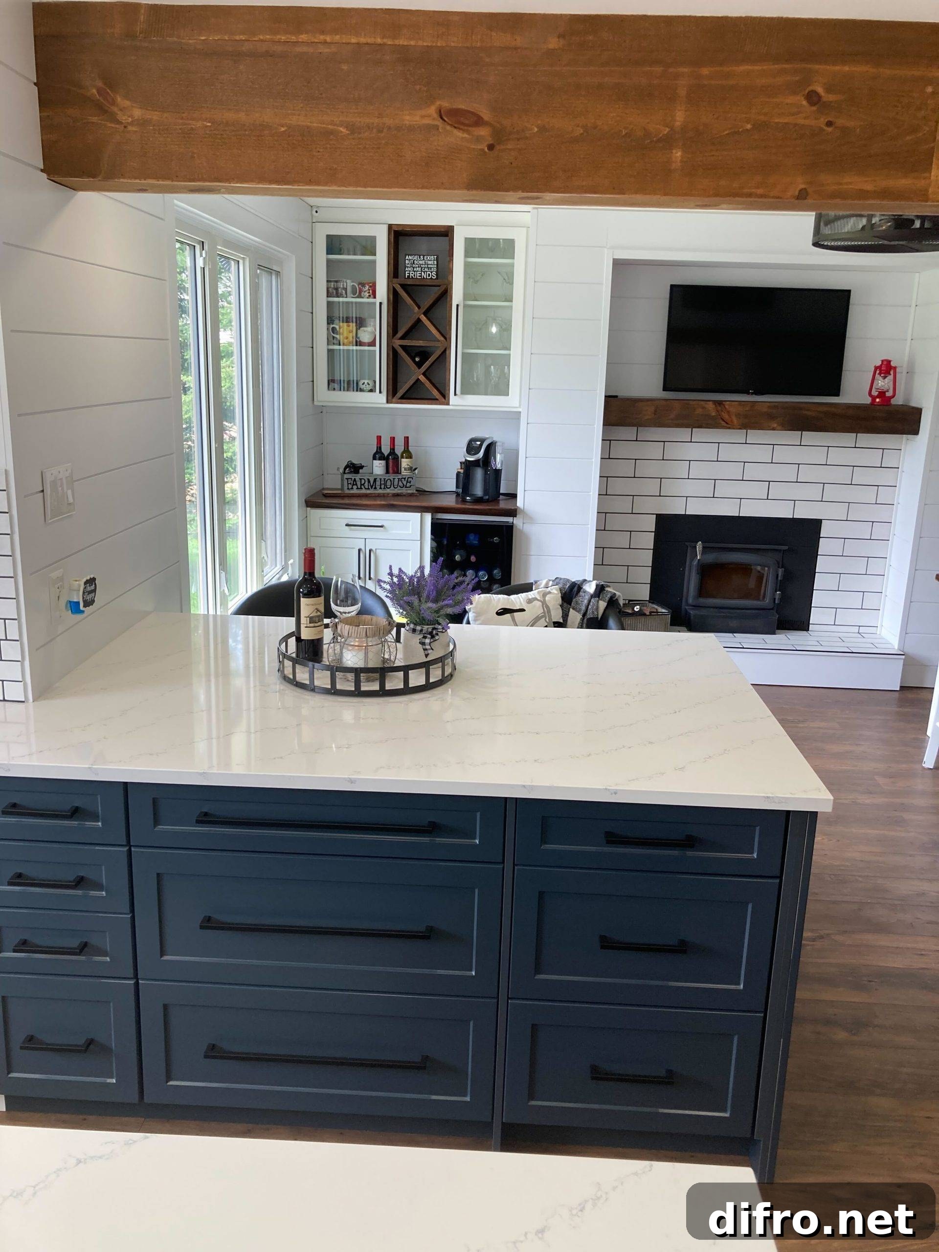 quartz kitchen countertops on blue cabinets with wooden beam overhead