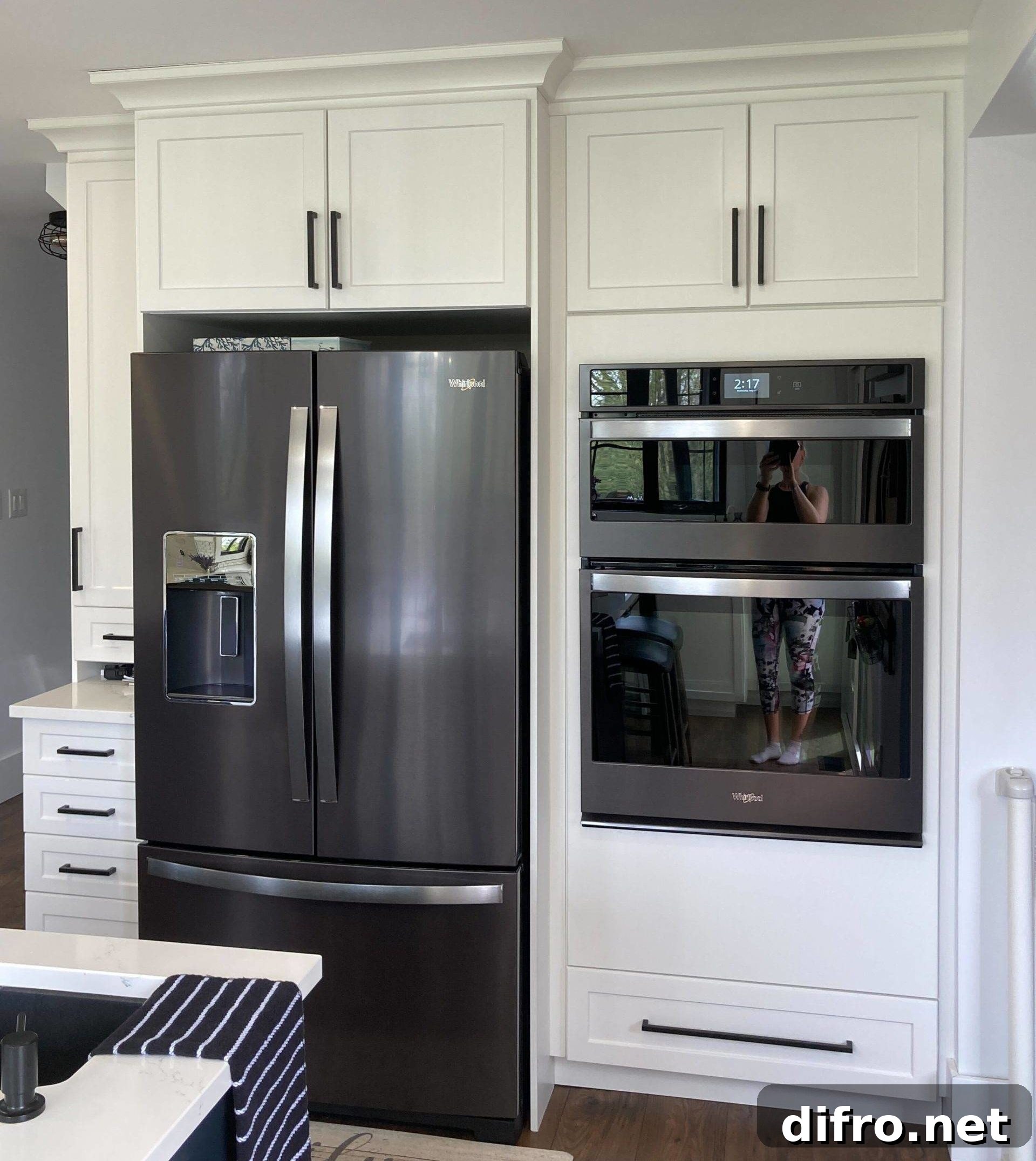 black stainless steel kitchen appliances against white cabinets