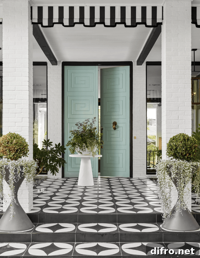 Mint green doors on a modern front porch tile black and white with pin stripe awning