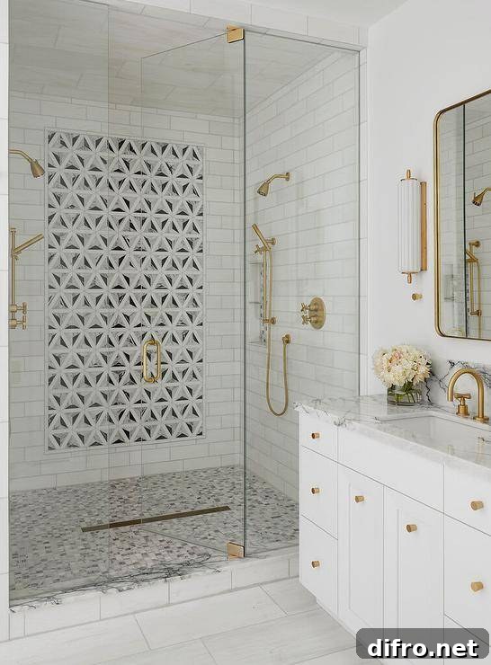 43 Walk-In Shower Ideas to Transform Your Bathroom 14 walk in shower with mosaic tile design art piece in middle gold shower kit white vanity with gold hardware wall light sconce glass doors