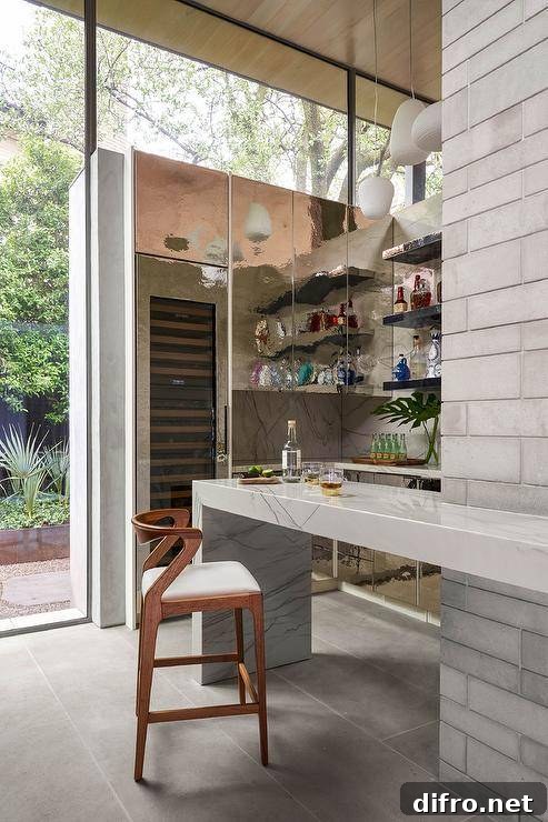 Stylish wet bar boasts a tall glass front wine fridge beneath iridescent cabinets mounted against a marble slab backsplash.