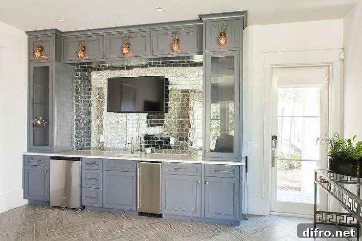 blue cupboards wet bar with television mirrored subway tiles