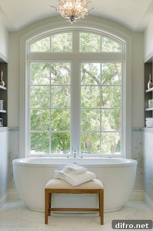 Freestanding tub under arched windows