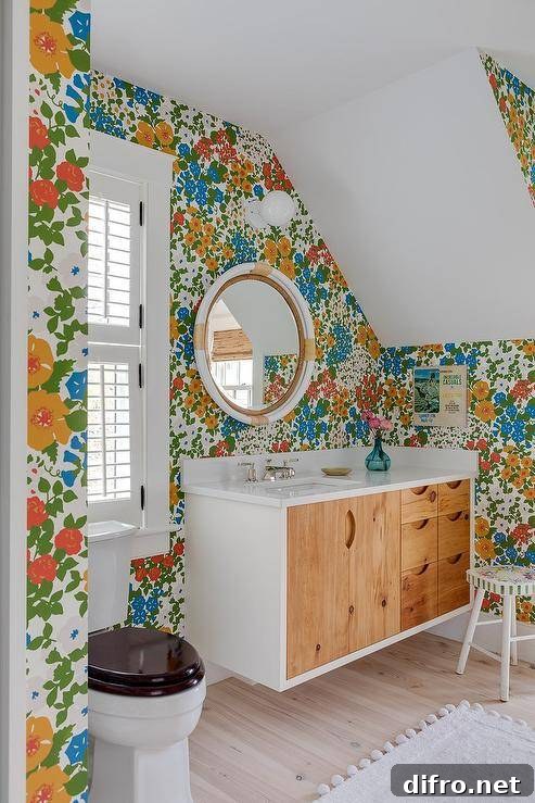 Colorful floral wallpaper above reclaimed wood washstand in a bathroom