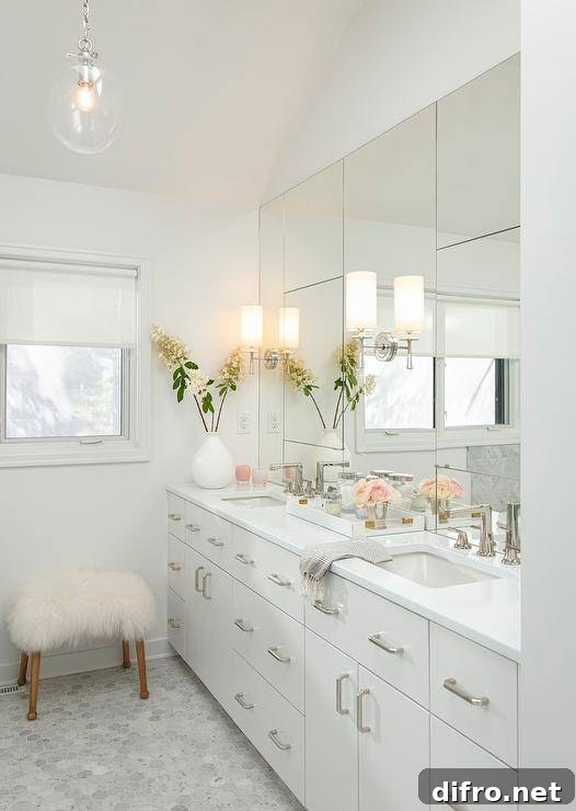 Large mirrored vanity reflecting a bright master bathroom