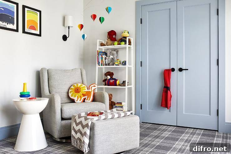 Transitional gray boy's nursery features powder blue double closet doors with black handles, white toy shelf, gray wingback nursery glider, nursery hot air balloons mobile and gray plaid carpeting.