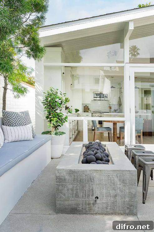 Patio with a built-in sofa and a rectangular concrete fire pit.
